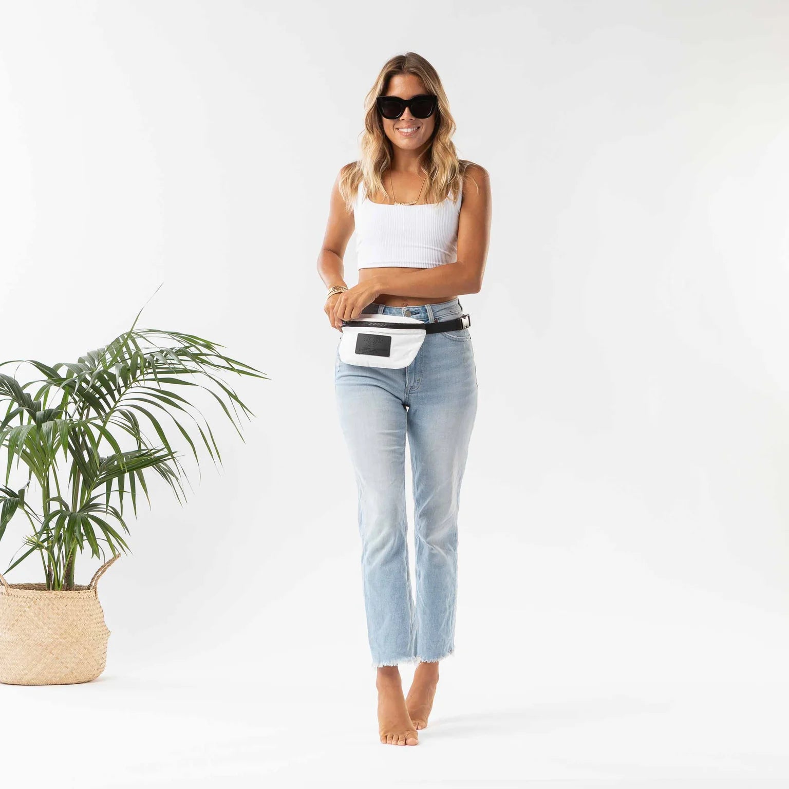 The Aloha white mini hipster with black strap keeps your items close to you.